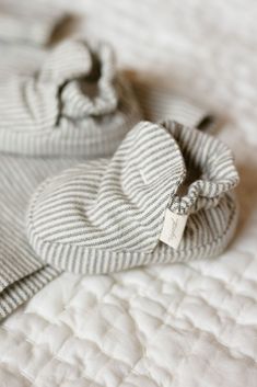 a white and blue striped blanket on top of a bed