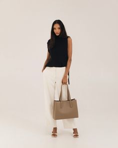 Polished work bag, meet casual weekend tote. Designed from the inside-out with a thoughtful system of interior pockets and card slots, and handcrafted in our supple, soft-yet-structured vegan ultrafiber leather. Fits 13-14” laptops (measured diagonally) with ease, and center divider means you can even carry two safely. Features a structured base that keeps the bag standing upright even when full, comfortable 2cm wide straps that won't dig into your shoulder, and a handy key leash to keep your ke Chic Brown Laptop Bag For Work, Taupe Soft Leather Work Bags, Versatile Leather Laptop Bag For Work, Structured Soft Leather Bag For Work, Minimalist Structured Shoulder Bag For Work, Chic Laptop Bag For Work, Taupe Tote Bag For Work, Rectangular Workwear Shoulder Bag With Interior Card Slots, Chic Satchel With Interior Card Slots And Double Handle