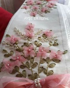 pink flowers and pearls on white fabric