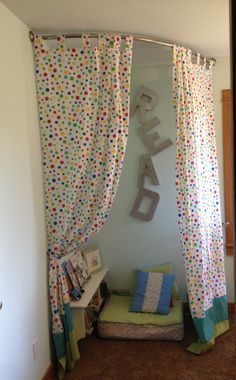 a child's bedroom with polka dot curtains