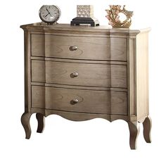 a wooden dresser with three drawers and a clock on top