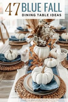 a dining table set with white pumpkins and blue napkins on top of it