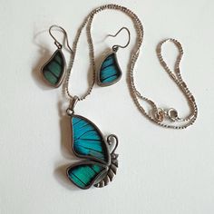 These amazing set of butterfly earrings and necklace are very special as they are made from real butterfly wings!  They are reversible so you can see the colour on one side and browns on the underside. Very unique set for the butterfly lover!  Price is for the set of earrings and necklace. Size: Pendant - 18" chain, pendant 1.5" drop, Earrings 1 1/2" drop Condition - Excellent MARKING: 950 (which has a higher silver content than 925) To see my other jewelry, click here: https://etsy.me/3A8crke T Silver Butterfly Jewelry With Matching Earrings, Silver Jewelry With Butterfly Charm, Unique Butterfly-shaped Jewelry With Matching Earrings, Elegant Turquoise Butterfly Jewelry, Unique Sterling Silver Jewelry With Butterfly Charm, Blue Butterfly Sterling Silver Jewelry, Turquoise Butterfly Jewelry For Gifts, Turquoise Butterfly Jewelry For Gift, Turquoise Butterfly Sterling Silver Jewelry