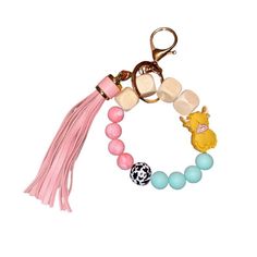 a bracelet with charms and tassels is shown on a white background for use as a keychain