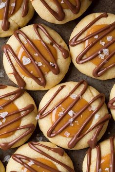 cookies with caramel and chocolate drizzled on top are arranged in rows