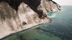 an aerial view of the ocean and cliffs