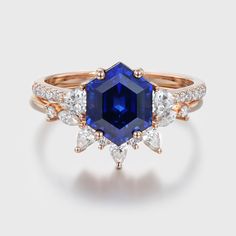 an engagement ring with a blue sapphire surrounded by diamonds