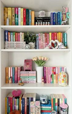 the bookshelves are filled with many different types of books and flowers in vases