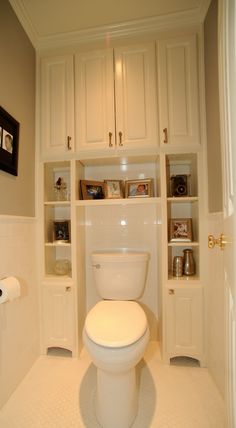 a white toilet sitting inside of a bathroom