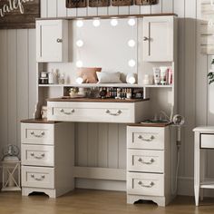 a white vanity with lights on it in a room next to a table and chair