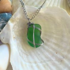 1 inch green seaglass pendant, wrapped in stainless steel wire comes with stainless steel chain standard 18 inch length (unless otherwise specified). Beautiful piece handpicked from the Great Lakes and wrapped with love and care to always keep a piece of the beach with you. Green Glass Wire Wrapped Necklaces, Green Glass Wire Wrapped Necklace, Wire Wrapped Green Glass Jewelry, Green Wire Wrapped Glass Jewelry, Wire Wrapped Sea Glass Jewelry For Gifts, Wire Wrapped Sea Glass Jewelry Gift, Silver Wire-wrapped Necklace With Recycled Glass, Silver Wire Wrapped Necklace With Recycled Glass, Wire Wrapped Silver Sea Glass Necklaces