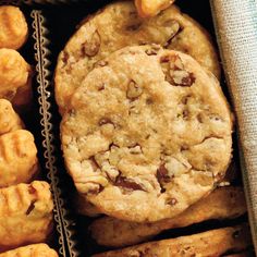 a box filled with lots of cookies and muffins on top of a table