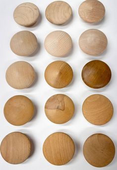 several different types of wooden discs on a white surface