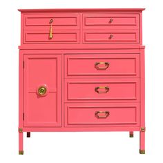 a pink dresser with gold handles and drawers