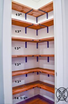 an empty closet with wooden shelves and blue piping on the ceiling is seen in this image