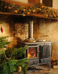 an old fashioned stove in front of a christmas tree