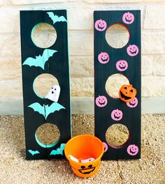 two halloween door hangers with pumpkins and bats on them