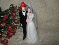 a wedding cake topper with a bride and groom