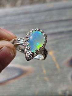 This Ethiopian water opal is incredibly dreamy all by itself, much less paired with this immaculate star and moon celestial band! Size 5, cannot be resized Iridescent Opal Jewelry For Anniversary, Spiritual Opal Promise Ring, Celestial Silver Opal Gemstone Ring, Celestial Opal Gemstone Ring, Celestial Oval Opal Rings, Mystical Cabochon Ring For Anniversary, Mystical Anniversary Ring With Cabochon, Iridescent Opal Ring With Gemstone, Spiritual Cabochon Opal Ring For Weddings