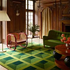 a living room filled with furniture and a green chair next to a fire hydrant