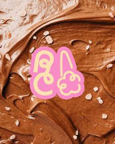 chocolate frosting with pink and yellow numbers on it