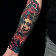 a woman's arm with a tattoo on it that has an image of a demon