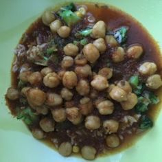 a white plate topped with beans and broccoli