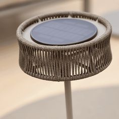 a wicker table with a solar panel on it's top is shown in close up