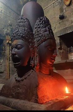 two buddha statues sitting next to each other