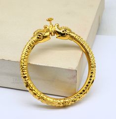 This is 22kt yellow gold bangle with amazing vintage elephant design face with screw system on closure, this bangle is filled by wax inside for durability, best wedding brides jewelry collection from india. Metal-22kt yellow gold. Item type-bangle Bracelet. Weight-30.450 grams approx. Size-select your size from options. Stamped-22ky/916 hallmarked. Note- this bangle is filled buy wax inside. Makes excellent gifting for birthday, Christmas day, mother's day, valentines day, wedding, anniversary. Antique Yellow Gold Jewelry For Puja, Yellow Gold Round Bangle For Puja, Heavy Yellow Gold Bracelets For Puja, 22k Gold Temple Jewelry With Openable Detail, Heavy Yellow Gold Bangle For Puja, Temple Jewelry In 22k Gold, Openable 22k Gold Temple Jewelry, Ceremonial Temple Jewelry Gold Bracelet, Yellow Gold Plated Temple Jewelry Bangle