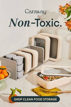 there are four non - toxic containers on the counter next to oranges