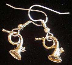 a pair of earrings with bells on them