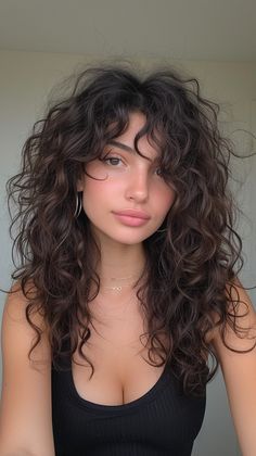 Transform your look with these 12 trendy haircuts, designed to flatter and accentuate round face features. Modern Shag Haircut Curly Hair, Long Haircuts With Bangs Curly, Mid Length Hair For Curly Hair, Type 2b Curly Hair Haircuts, Long Naturally Curly Haircuts, Wavy Hair Perm Women, Shaggy Perm Long Hair, 2b Curly Hair Bangs, Triple Unicorn Haircut Curly Hair