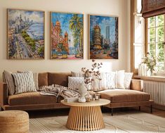 a living room with three paintings on the wall