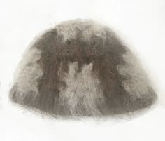 a pile of gray wool sitting on top of a white surface