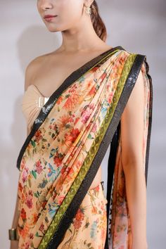 Multicolor floral print and sequin panel half half pre draped saree. Comes with padded tube blouse.
Components: 2
Pattern: Printed
Type Of Work: Floral
Neckline: Sweetheart
Sleeve Type: Sleeveless
Fabric: Georgette, Sequin georgette
Color: Multi Color
Other Details: 
Blouse front buckle detail
Length:
Blouse: 14.5 inches 
Saree :43  inches 
Model Height: 5ft 8inches wearing size S
Closure: Saree: Side zip
Occasion: Sangeet,Mehendi and Haldi - Aza Fashions Multicolor Floral Print Choli For Party, Multicolor Floral Print Party Choli, Multicolor Georgette Blouse For Reception, Party Wear Floral Print Choli With Traditional Drape, Designer Multicolor Floral Print Choli, Designer Floral Print Multicolor Choli, Multicolor Floral Print Blouse For Designer Wear, Party Choli With Floral Print And Traditional Drape, Multicolor Blouse Piece With Sheer Dupatta For Reception