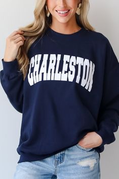 Calling all Charleston residents, the Navy Charleston Sweatshirt was made just for you! This comfy sweatshirt is designed with a soft and stretchy knit with a fleece interior. It features a crew neckline, long sleeves, a relaxed fit, and the word "Charleston" on the front. Style the Navy Charleston Sweatshirt with your favorite denim and sneakers for a casual look! Soft + Stretchy Knit Fabrication Fleece Interior "Charleston" Graphic Crew Neckline Long Sleeves Relaxed Fit 80% Cotton, 20% Polyest Varsity French Terry Crew Neck Sweatshirt, Long Sleeve French Terry Sweatshirt For College, French Terry Long Sleeve Sweatshirt For College, Game Day Crew Neck Sweater With Ribbed Cuffs, Stretch Crew Neck Sweatshirt For Fall, Oversized Crew Neck Sweatshirt For Game Day, Game Day Long Sleeve Letter Print Sweater, Fall Sweatshirt With Letter Print, Long Sleeve Sweats With Text Print For Fall