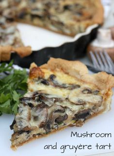 mushroom and arugula tart on a white plate with a fork next to it