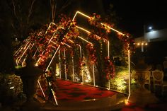 A customised entry porch created for a sangeet ceremony, decorated with led lights and flowers. Sangeet Entry Passage Decor, Sangeet Stage Decor With Led Screen, Sangeet Entry Decor, Event Entry Gate Design, Sangeet Led Stage, Marriage Entry Gate Decoration, Sangeet Entrance Decor, Sangeet Theme Ideas, Wedding Entry Decor