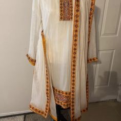 Pakistani Indian Three Piece Formal Dress. Shirt And Dupata Have Beautiful Patch Work Embroidery . Size Approximately Shoulder 15”Bust 22”Waist 19.5”Hip 22”Arm 22.5”Length 38”Shalwar Length 38”Fabric Is Crinkle Chiffon. Condition Is Pre-Owned. Festive White Tunic Set, White Blouse With Dupatta For Eid, Long Sleeve Chanderi Salwar Kameez, Embroidered Chanderi Cream Dress, Cream Embroidered Chanderi Dress, Embroidered Cream Chanderi Dress, White Tunic Sets For Eid, Cream Long Sleeve Salwar Kameez For Navratri, Long Sleeve Cream Salwar Kameez For Navratri