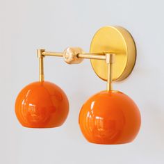 an orange pair of lights hanging from a wall