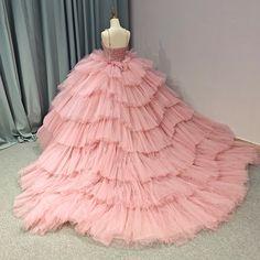 a mannequin is dressed in a pink dress with ruffles on it