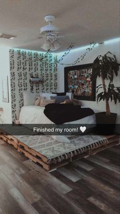 a bedroom with wood floors and a bed made out of pallet boards that says finished my room