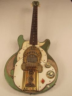 an old guitar is hanging on the wall