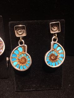 "- 284R is NO LONGER AVAILABLE. This listing is now just for the turquoise earrings. 2 fine earring sets... each are handmade dangle / drop earrings with gold spirals set in sterling silver box posts, with gold jump rings & sterling silver settings surrounding the natural ammonites, the 1st with abalone inlay, the 2nd with turquoise inlay... both by Santa Fe jewelry artist Samayra Sinclaire. *-THIS PAIR HAS SOLD- Ammonite with abalone inlay, sterling silver & 14K gold earrings alone (the Unique Turquoise Jewelry With Polished Finish, Unique Spiral Sterling Silver Jewelry, Unique Polished Drop Earrings, Elegant Drop Earrings With Inlay, Handmade Turquoise Spiral Jewelry, Handmade Spiral Turquoise Jewelry, Blue Spiral Sterling Silver Jewelry, Unique Blue Spiral-shaped Jewelry, Handmade Spiral Jewelry For Anniversary