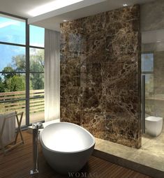 a bathroom with a large stone wall next to a bathtub