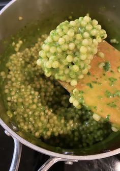 peas being cooked in a saucepan on the stove