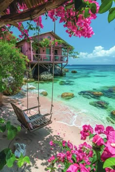 a hammock hanging from the side of a beach next to water and flowers