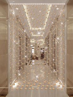 an image of a hallway with lights on the ceiling and walls in the room that looks like it is made out of beads