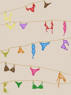 colorful bikinis are hanging on a clothesline with no shoes or bras attached to them